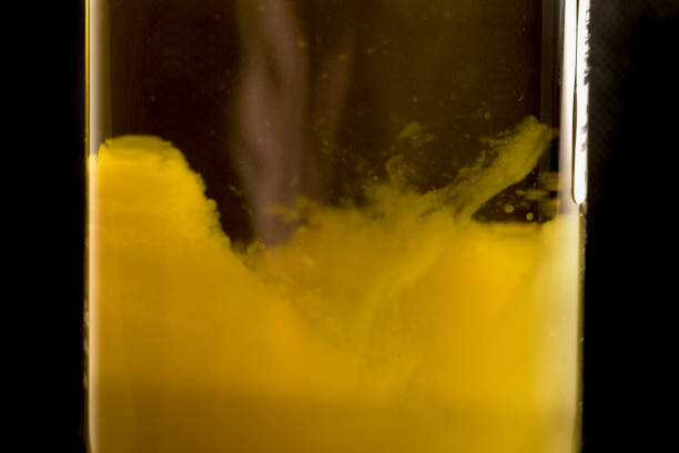 Texture of bottle of virgin olive oil with solid grounds due to the cold black background