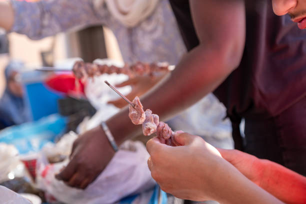 istock Multi ethnic peoples are in picnic and helping each other while preparing kebab and barbecue 2150986550