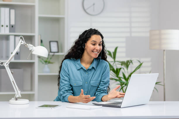 istock Hispanic woman happily working in a modern office setting 2150986643