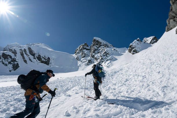 istock Backcountry skiers climb mountain 2150987805