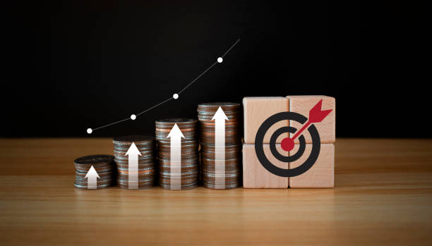 istock Coins stack with trading chart and wooden cube target in financial concepts and financial investment business. investment goals. financial annual plan for money, Budget, investment, financial,target. 2150988179