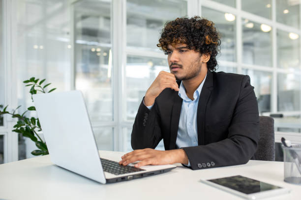 istock Young businessman deep in thought at modern office 2150988212