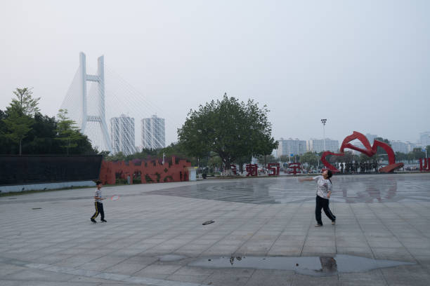 Baise City, Guangxi, China - March 30, 2023: Two children play badminton in an open space in a park