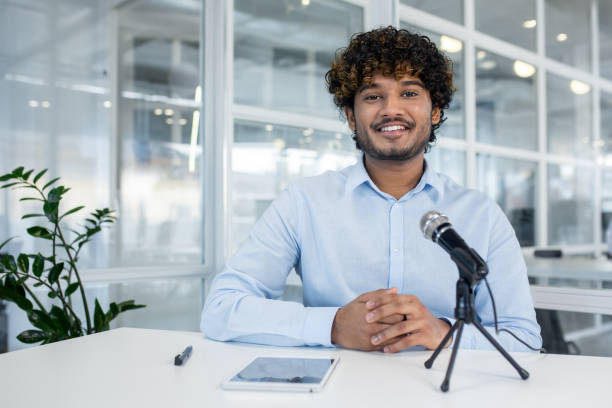istock Young businessman in video call with microphone and tablet 2150988808