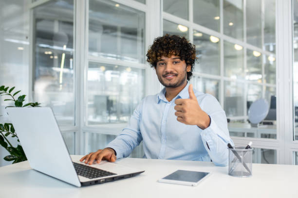 istock Confident young professional giving thumbs up in office 2150990067