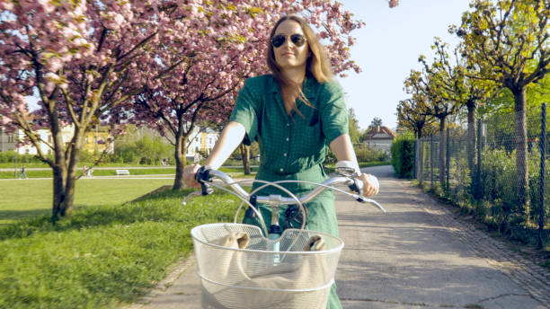 Young woman riding cruiser bike in park