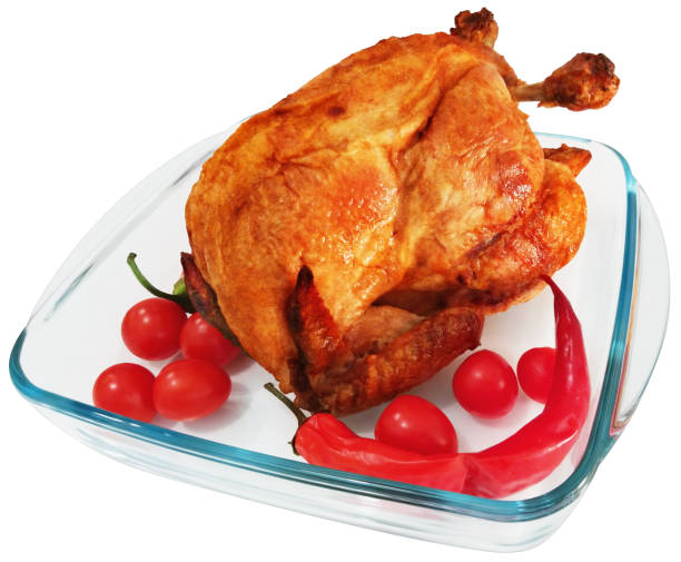 Grilled chicken wings, baked potatoes, herbs and spices on kitchen table, free space for text. Hot fresh appetizing countryside food. Cooking concept, meat dishes, homemade cuisine