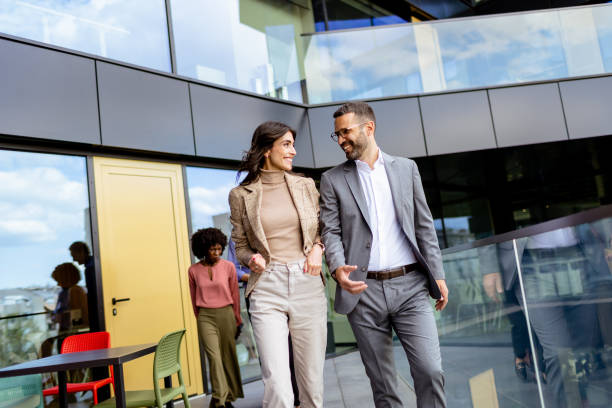 istock Cheerful Colleagues Exiting a Modern Office Building on a Bright Afternoon 2150994239