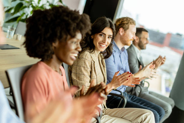 istock Energetic applause by a diverse group at a casual indoor event 2150994258