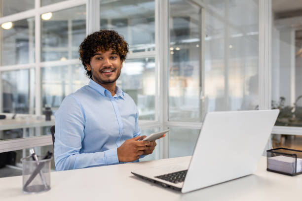 istock Professional man with laptop and smartphone in office 2150994420