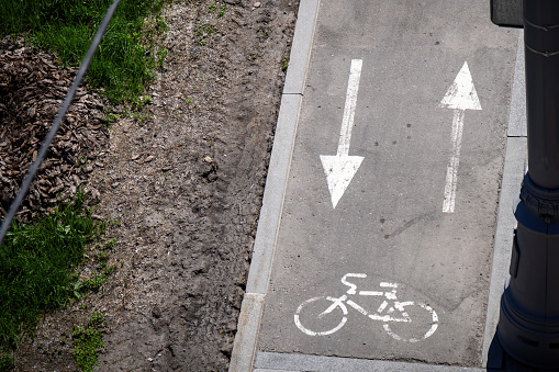 Bicycle lane sign on red road.