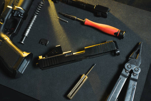 istock Gunsmithing, cleaning and repairing weapons. Disassembled pistol in a workshop. 2150996121