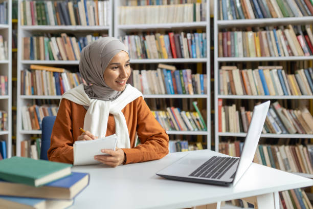 istock Muslim woman studying with laptop and notebook in library 2150996148