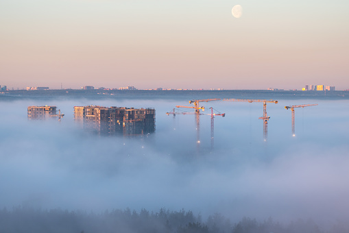 Residential buildings construction site in the morning fog