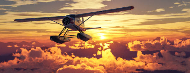 istock Airplane flying over mountains, lakes, and clouds. Sunny Da 2150999860