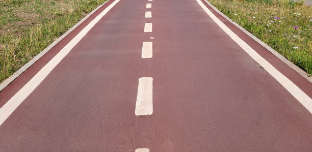 istock A red synthetic treadmill or bike path with white markings 2151001053