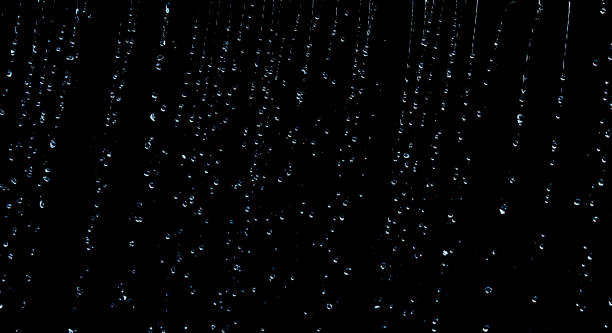 istock raindrops on a black background, water drops on a black background. 2151002323