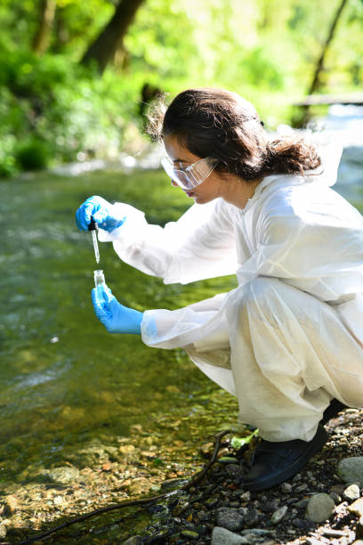 istock Female Scientist Collecting Water From Mountain River For Research 2151002756