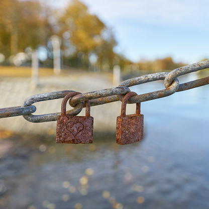 Rusted love locks on a chain on the Sundpromenade in Stralsund in germany