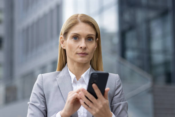 istock Professional businesswoman using smartphone in urban setting 2151003512