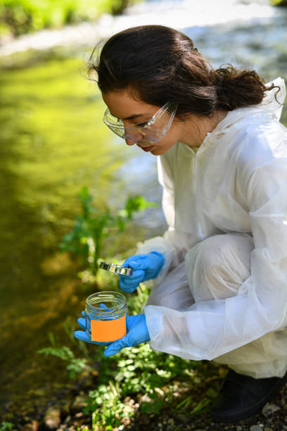 istock Female Scientist Displaying Focus During River Sample And Inspection 2151003565