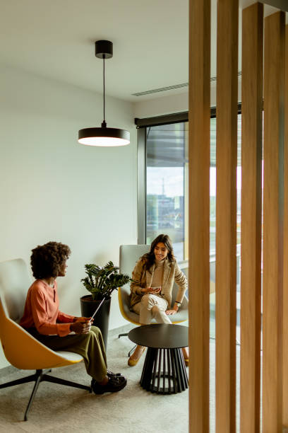 istock Serene afternoon chat between two friends in a modern apartment living space 2151003613