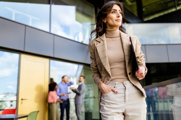 istock Confident young businesswoman walking with purpose at a modern office complex during the day 2151003642
