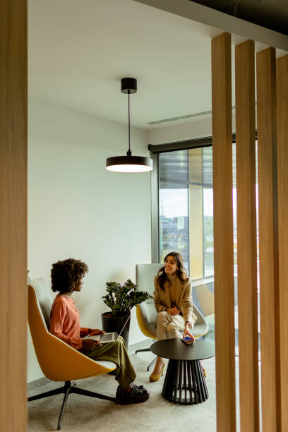 istock Serene afternoon chat between two friends in a modern apartment living space 2151003700