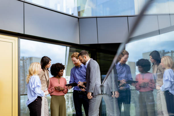 istock Business Professionals Engaging in a Strategy Discussion Outside a Modern Office Building 2151003726