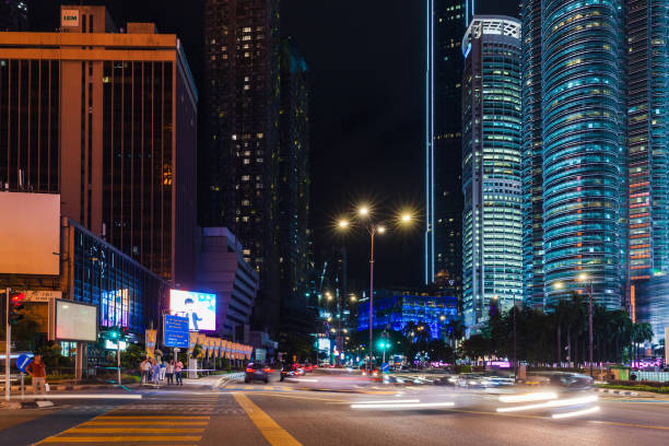 Kuala Lumpur, Malaysia - November 28, 2019: Kuala Lumpur downtown, night street view with cars and ordinary people on the street
