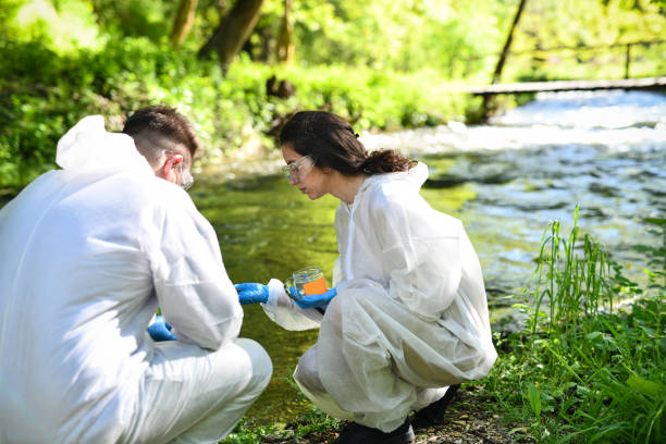 istock Focused Science Team And Their Project Of Gathering Rare Soil Types Around River 2151004073