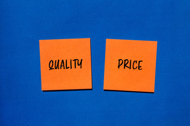 Quality price words written on orange stickers with blue background. Conceptual quality or price symbol. Copy space.
