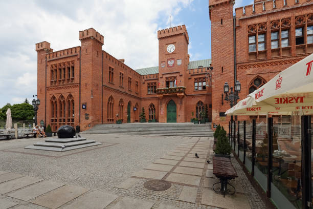 Kolobrzeg, Poland - June 18, 2019: There is a large brick building that is the town hall. Located in the centre of the city, this neo-Gothic building is a popular destination for many tourists.
