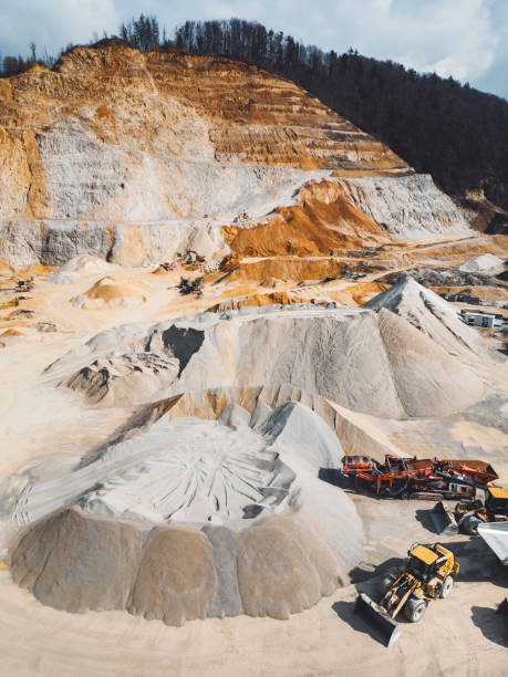 istock Vertical photo - Heavy machinery working on quarry grounds 2151004993