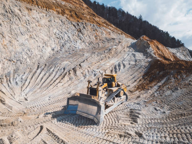 istock Excavator digging a hole in an open pit quarry, shoveling gravel 2151005005