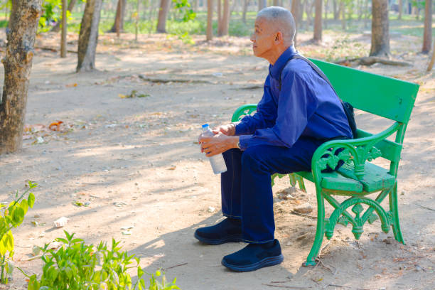 Thai senior man sitting on a bench