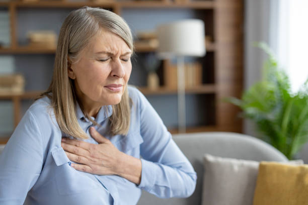 istock Senior woman feeling chest pain while sitting at home 2151005262
