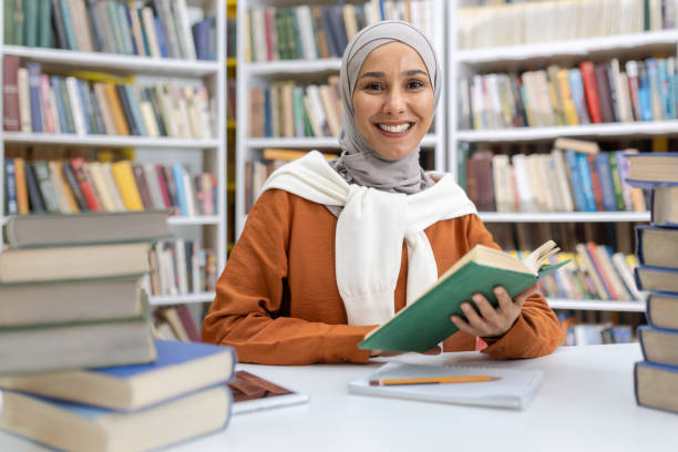 istock Muslim woman enjoying reading in a library setting 2151005940