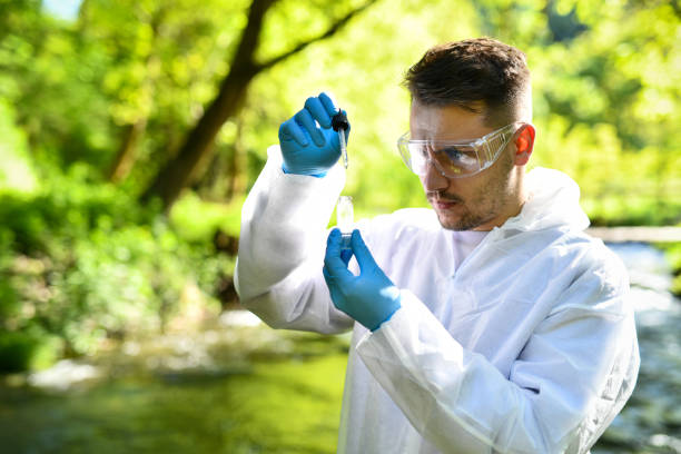 istock Male Scientist Inspecting Mountain River Water For Micro Organisms 2151006008