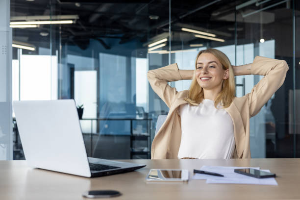 Confident businesswoman relaxing in a modern office space