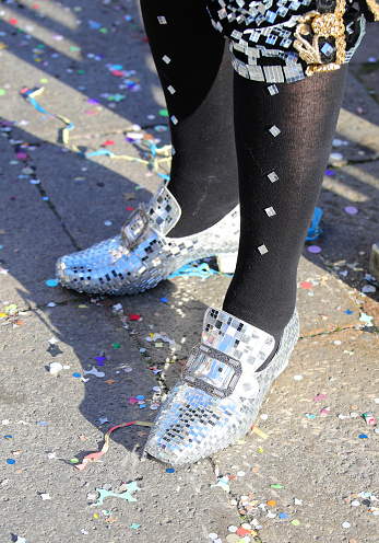 Extremely elegant moccasins made with thousands of micro-mirrors for a masquerade ball and carnival confetti on the ground in Venice