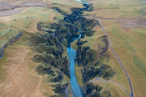 istock Vertical top view between hills in Iceland winding blue river, branch mountain stream. Tourism.. 2151006790