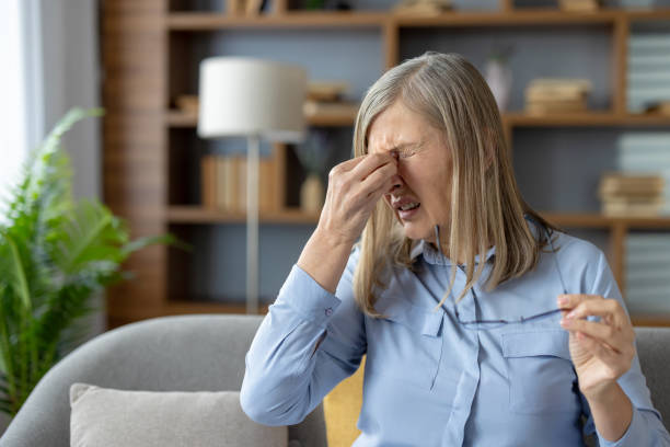 istock Senior woman feeling stressed with a headache at home 2151008207