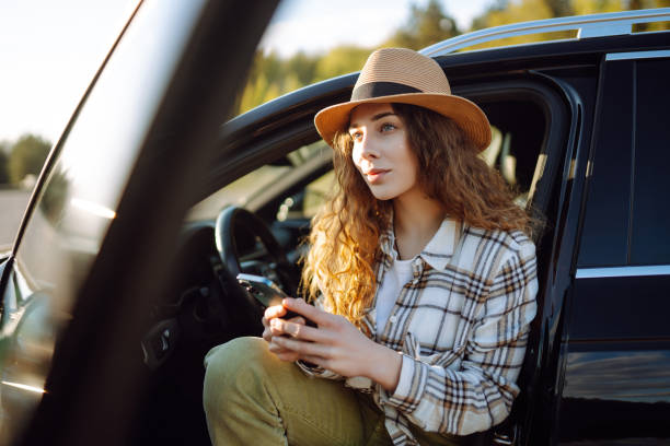 istock Happy young woman driver traveler using smartphone during travel. 2151008557
