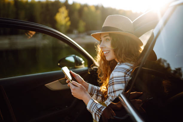 istock Happy young woman driver traveler using smartphone during travel. 2151008588