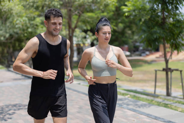 istock Happy couple enjoy jogging in a park 2151010334