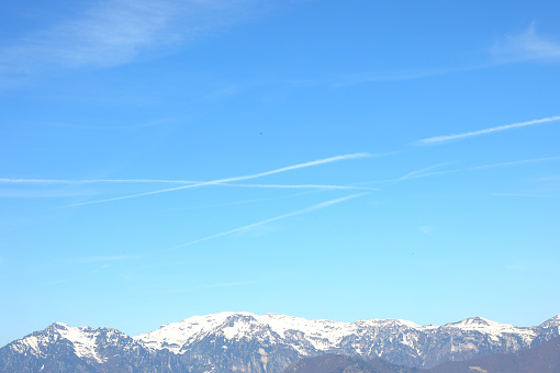 mountain panorama with white chemtrails left by the Ari or something else According to the conspiracy theory