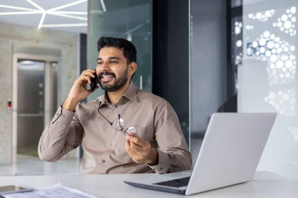 istock Smiling businessman on a phone call at a modern office 2151012902