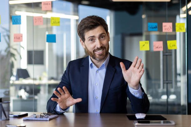 istock Businessman engaging in a lively video call in modern office 2151013431