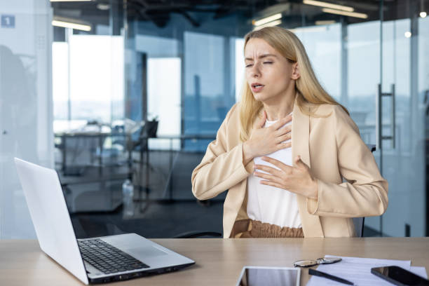 istock Businesswoman experiencing chest pain while working in office 2151014718